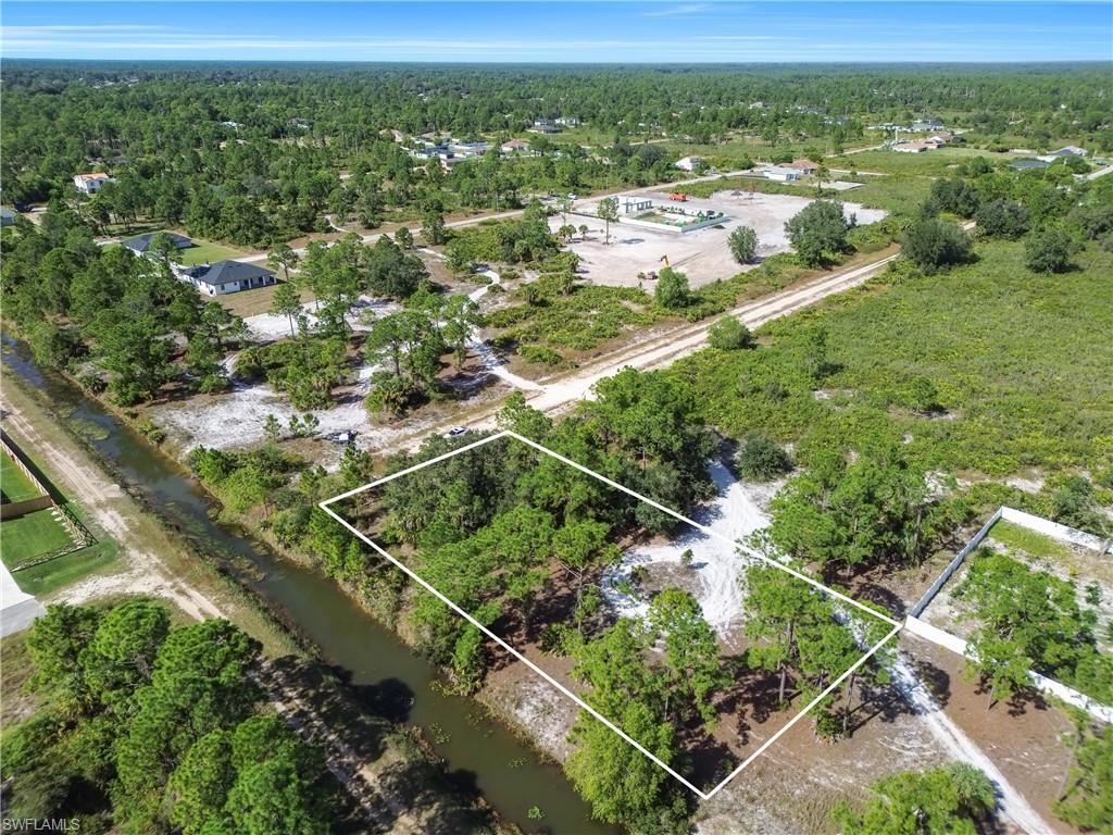 Aerial view of property's location featuring property boundaries highlighted and a forest