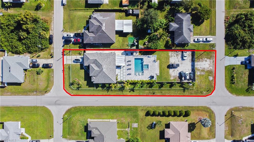 Aerial view of residential area featuring property boundaries highlighted