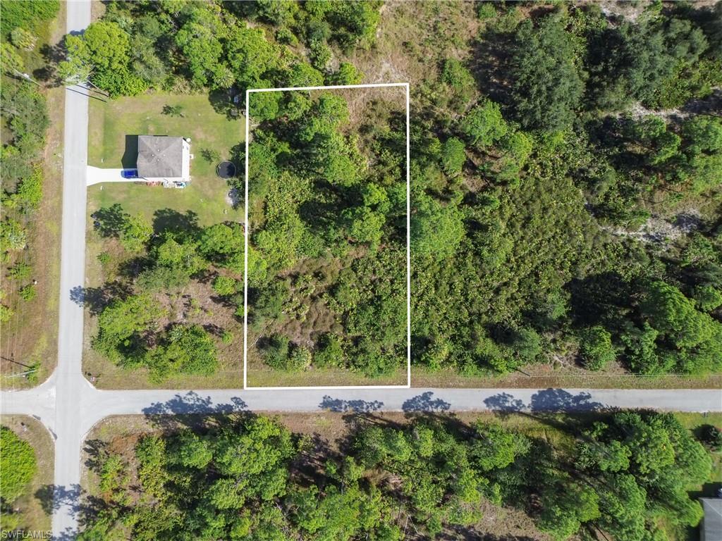 Aerial view of property and surrounding area featuring property parcel outlined