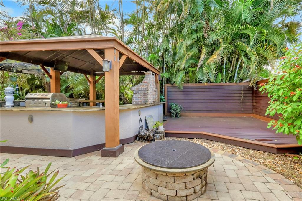 View of patio featuring a fire pit, area for grilling, and a deck