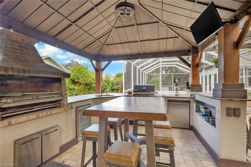 View of patio / terrace with area for grilling and a lanai