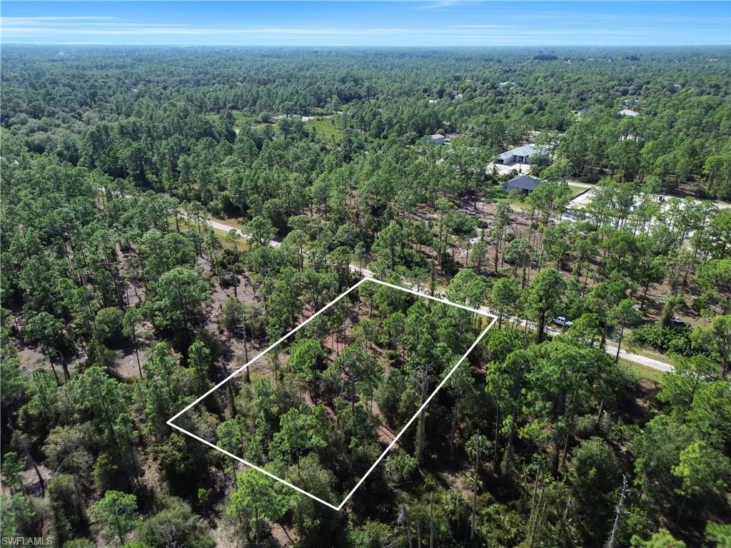 Aerial view of property's location with a forest and property parcel outlined