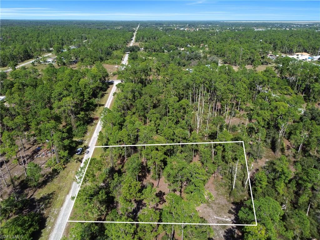 Aerial view of property's location featuring a heavily wooded area and property boundaries highlighted