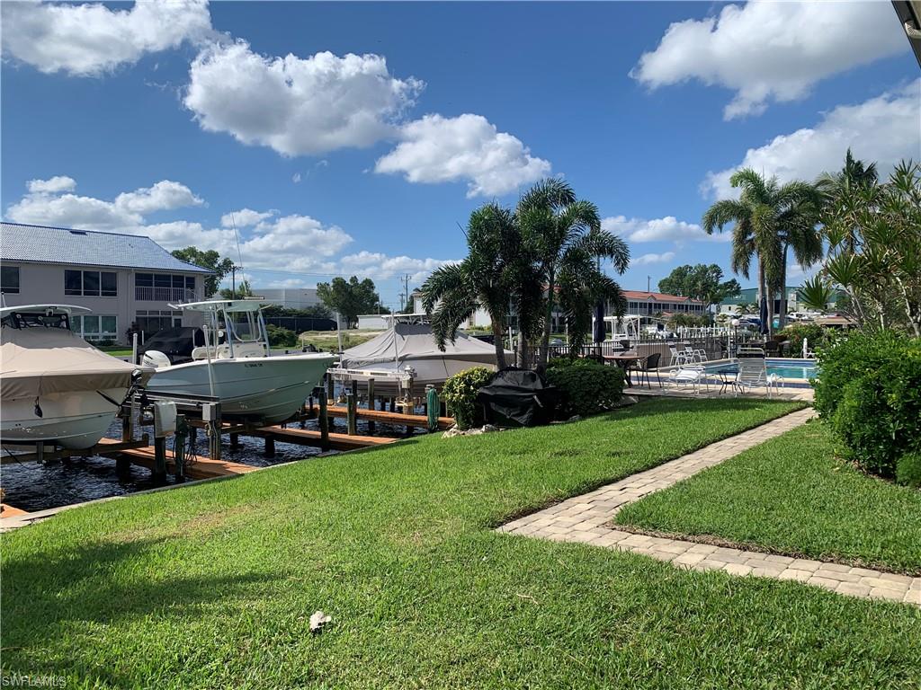 View of dock with a lawn