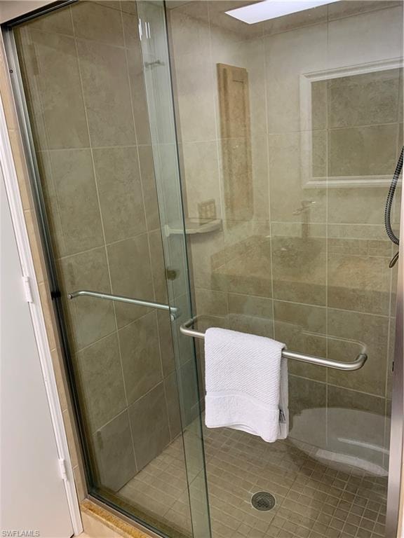 Bathroom featuring a shower with door