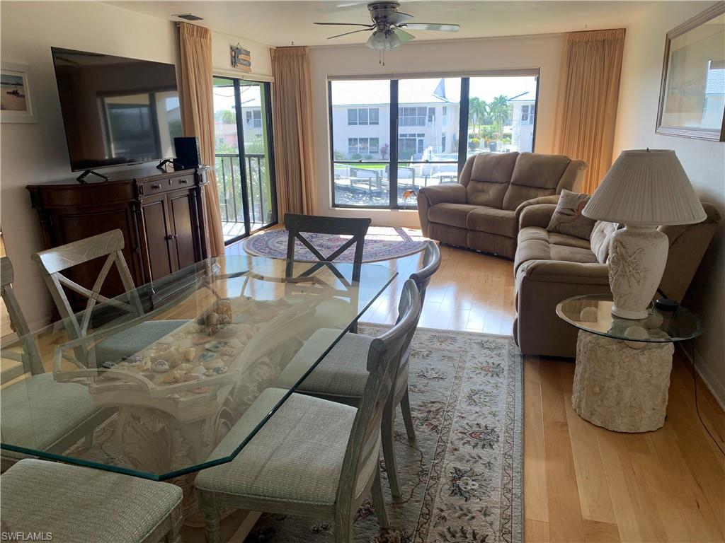 Living room with ceiling fan and light wood-type flooring
