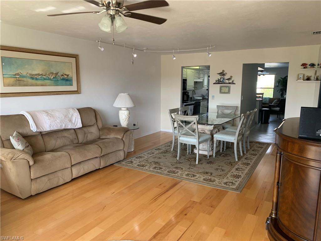 Living room featuring light wood-type flooring and ceiling fan