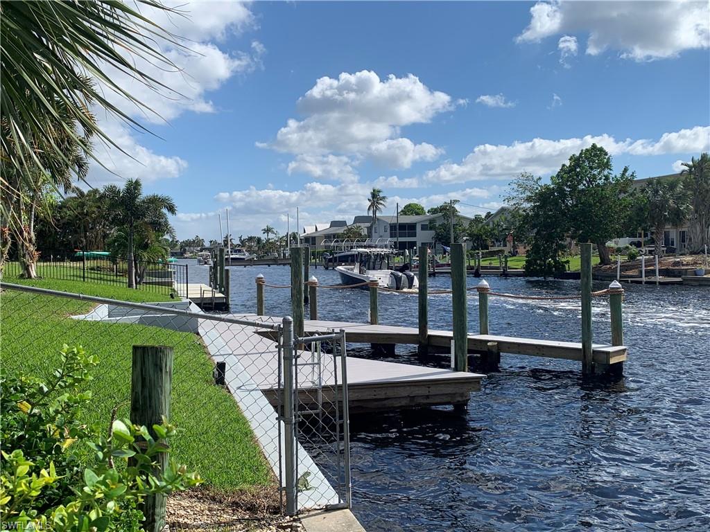 Dock area featuring a yard and a water view