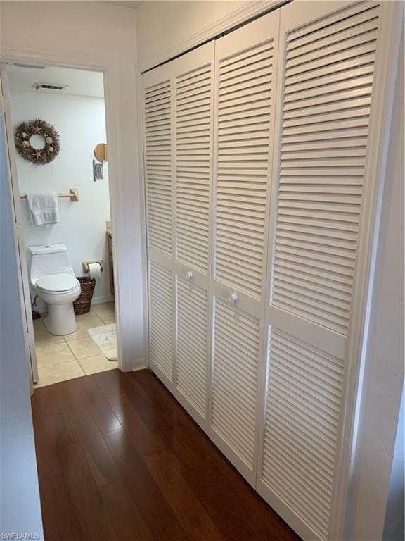 Hallway with hardwood / wood-style floors