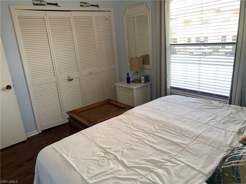 Bedroom featuring dark hardwood / wood-style flooring and a closet