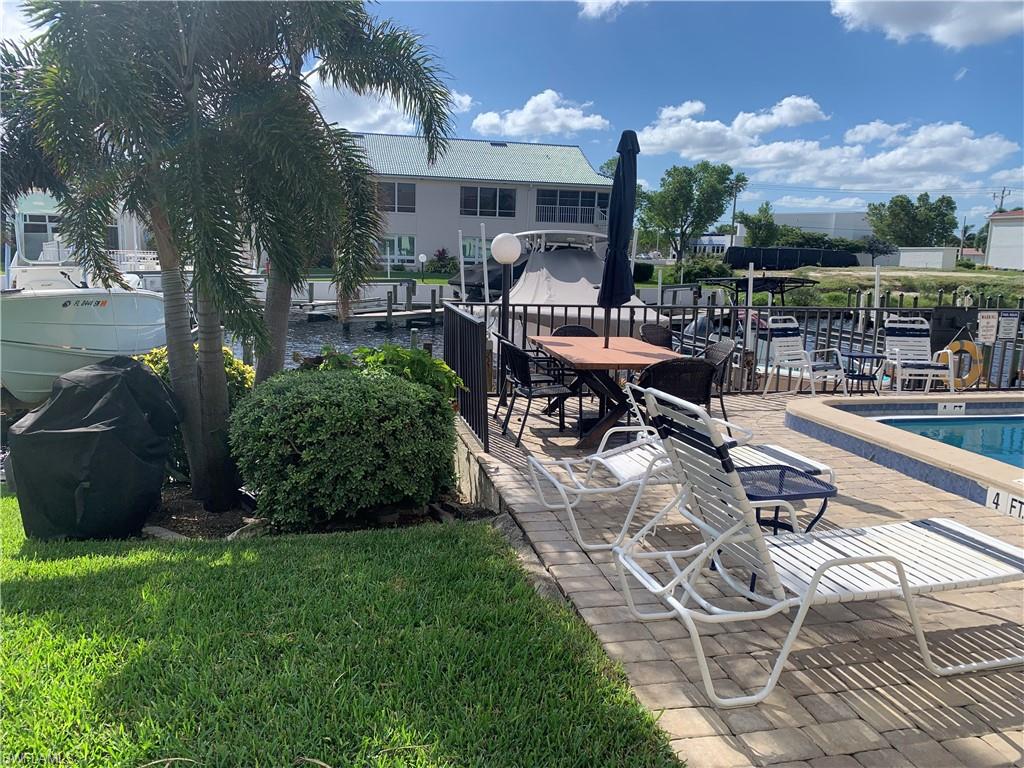 View of patio featuring a water view and a community pool