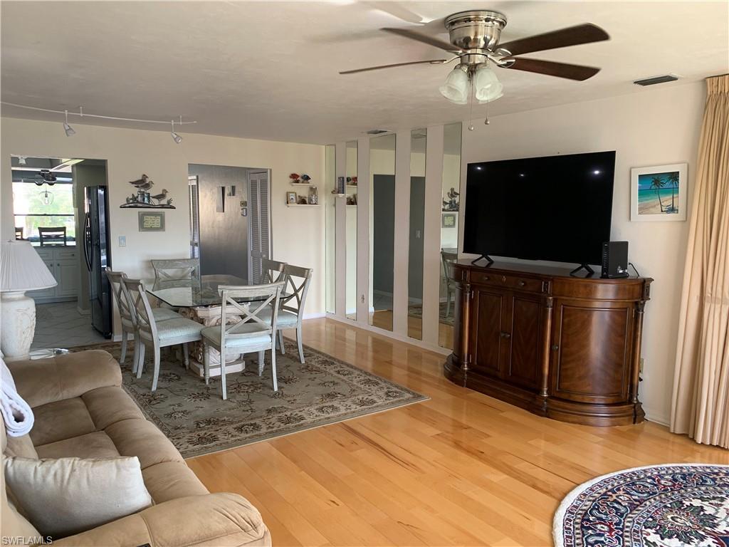 Living room featuring ceiling fan and light hardwood / wood-style floors