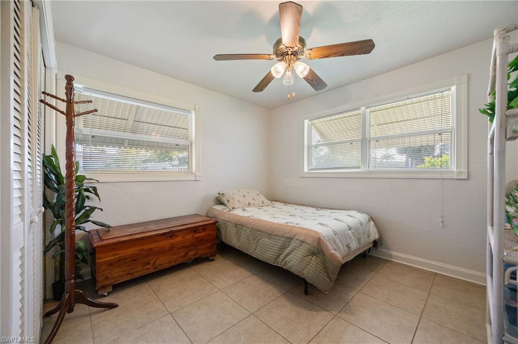 Bedroom featuring light tile patterned flooring and a ceiling fan