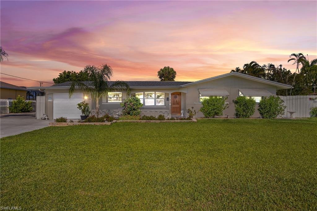 Ranch-style house featuring a garage and concrete driveway
