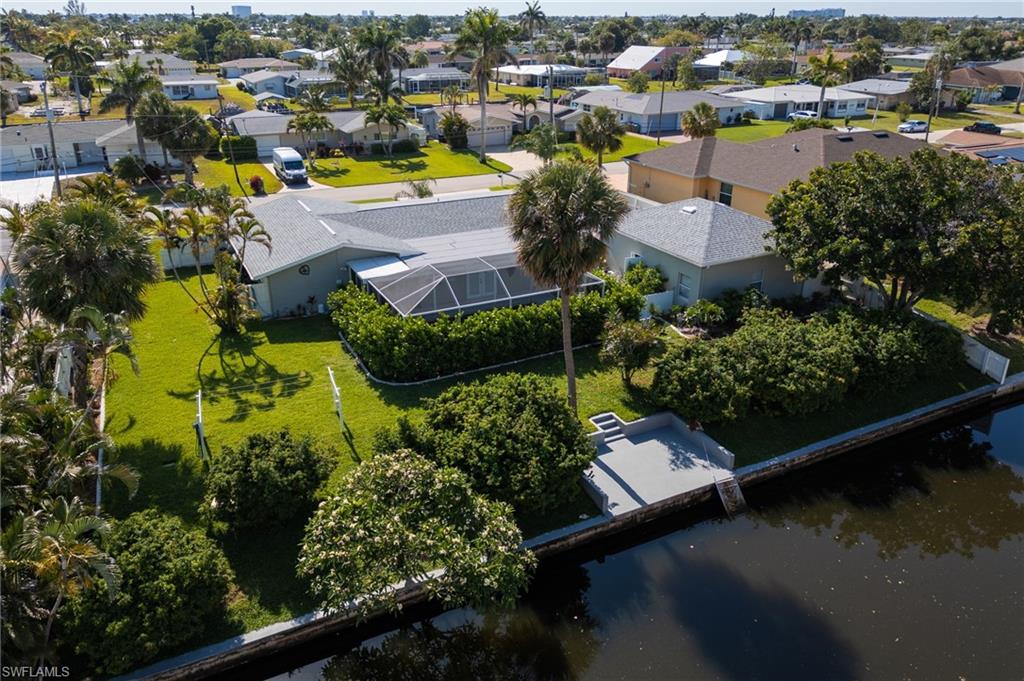 Aerial perspective of suburban area featuring a large body of water