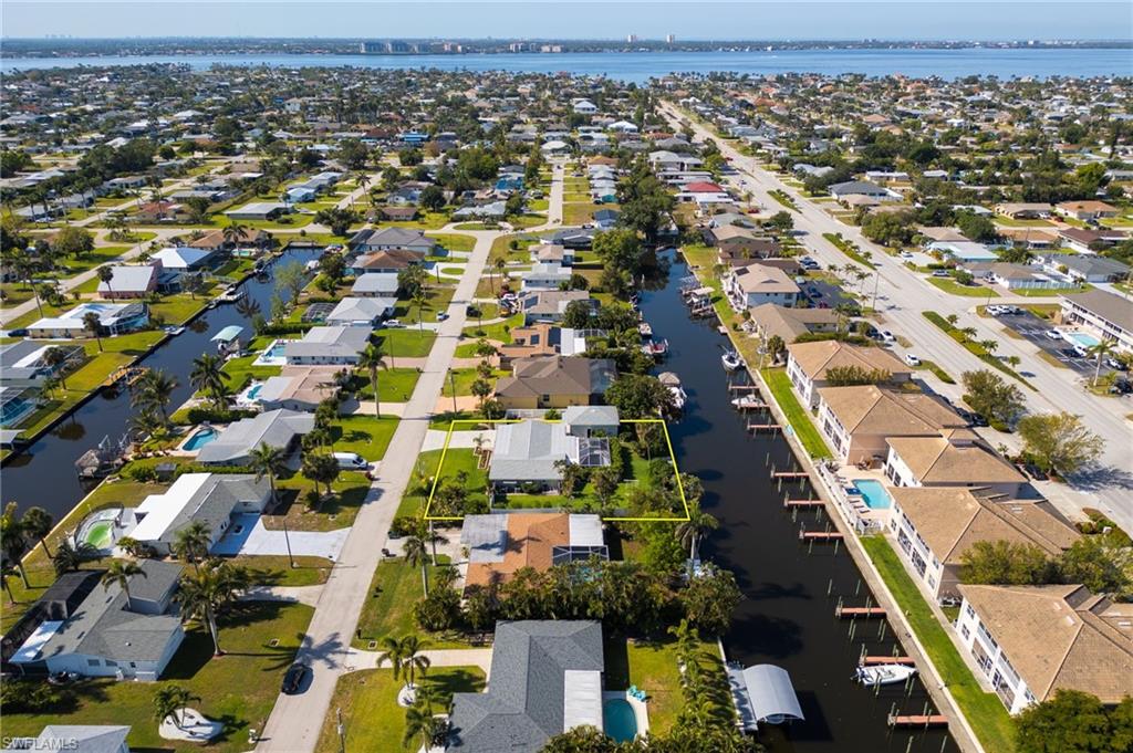 View of property location featuring a nearby body of water and nearby suburban area