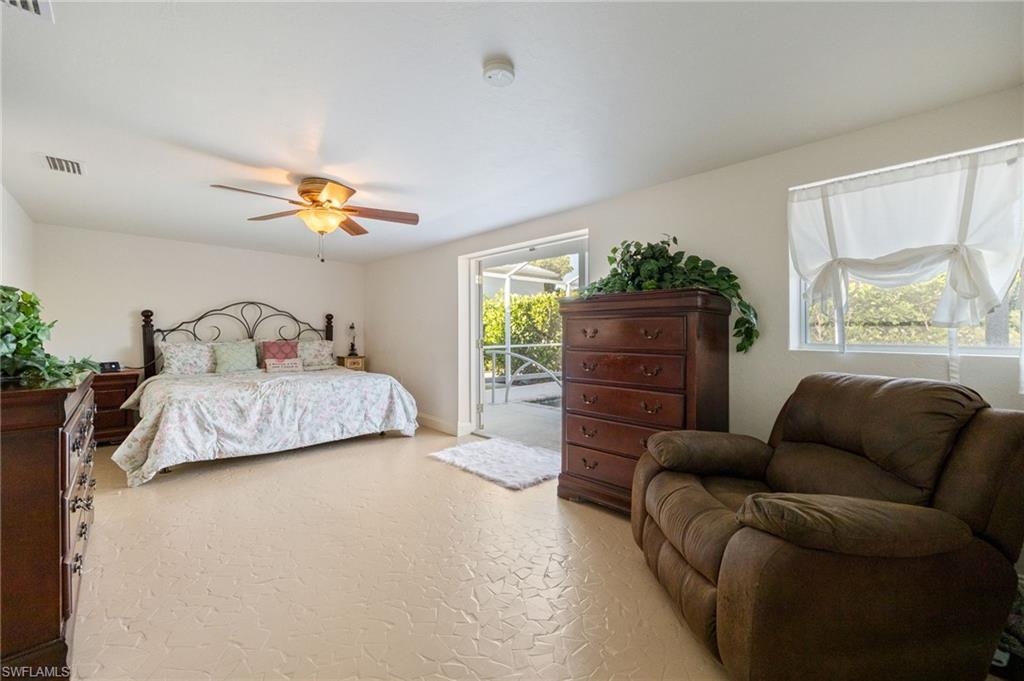 Carpeted bedroom with access to exterior and ceiling fan