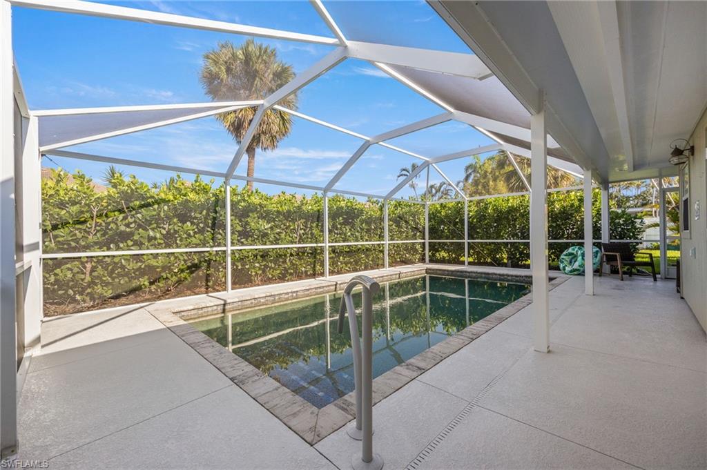 Outdoor pool featuring a patio area, a sunroom, and a lanai