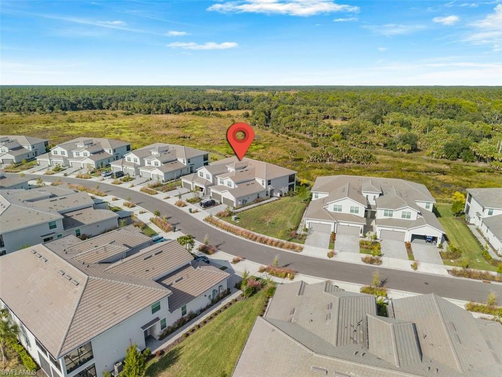 Aerial view of residential area featuring a heavily wooded area