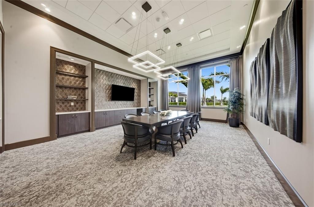 Dining room featuring light colored carpet, ornamental molding, and recessed lighting