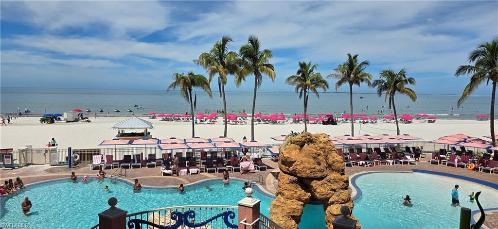 Community pool with view of water and beach