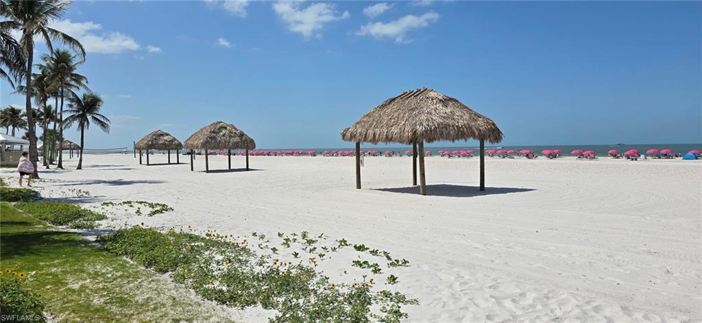Surrounding community with view of water and beach
