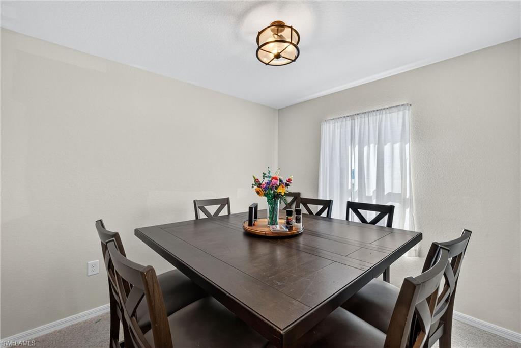 Dining area with baseboards and a textured wall