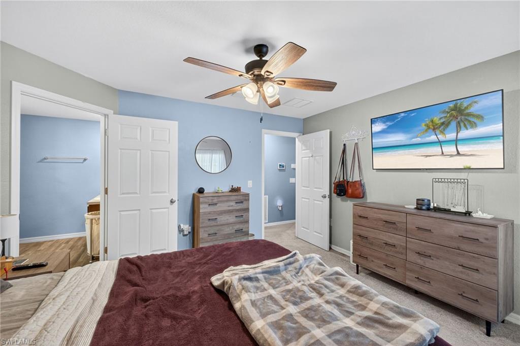 Carpeted bedroom featuring baseboards and ceiling fan