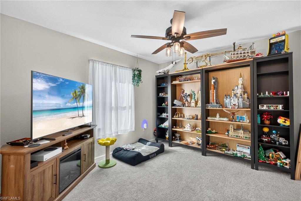 Playroom featuring light carpet and ceiling fan