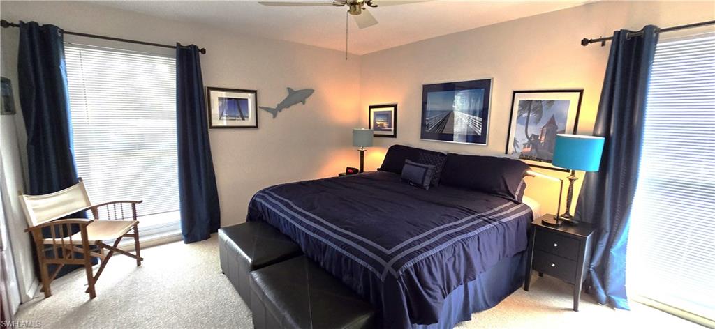 Bedroom with light carpet and ceiling fan