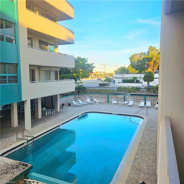 Community pool with a patio and a balcony