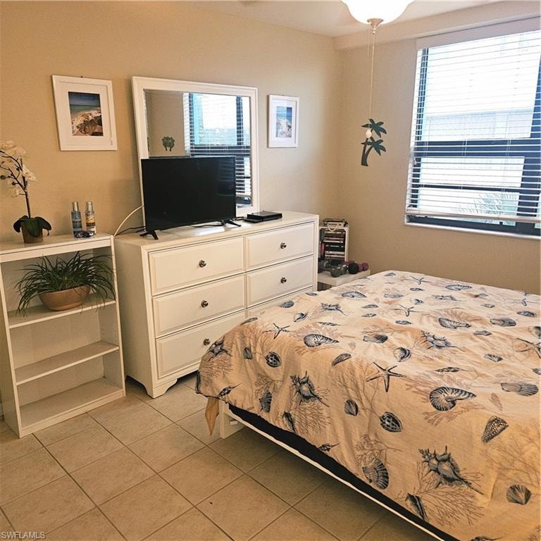 Bedroom with light tile patterned flooring and a ceiling fan