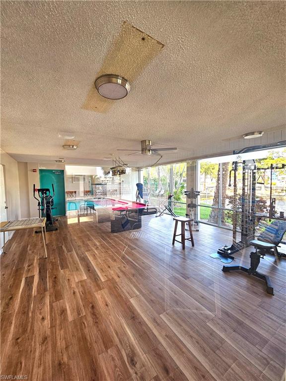 Workout area with a wall of windows and a textured ceiling