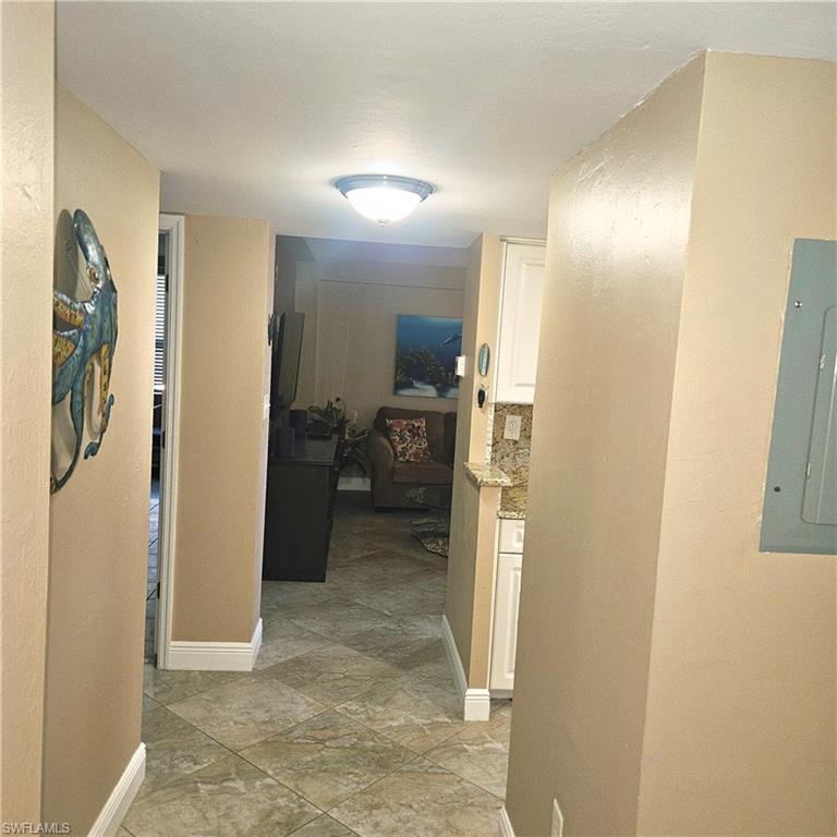 Corridor with electric panel and a textured wall
