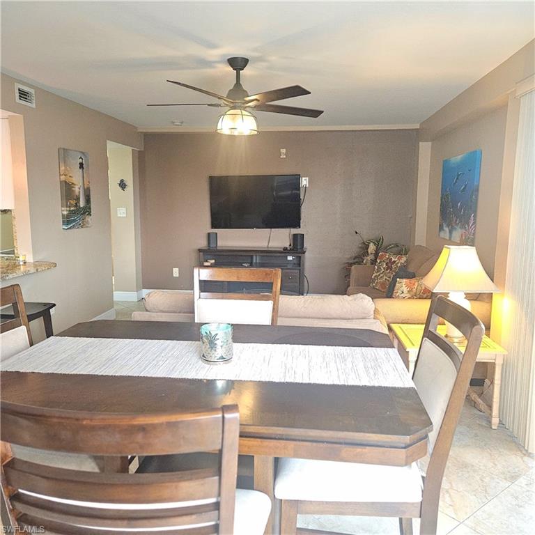 Dining room featuring a ceiling fan and baseboards