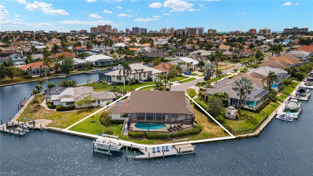 Aerial view of residential area featuring a large body of water and skyline