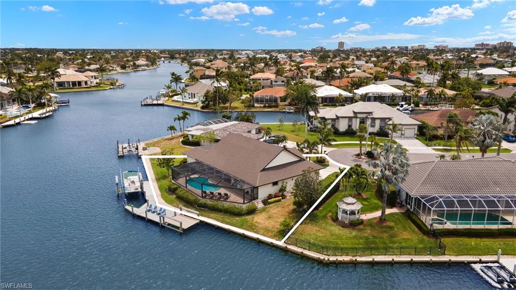 Aerial view of residential area featuring a nearby body of water