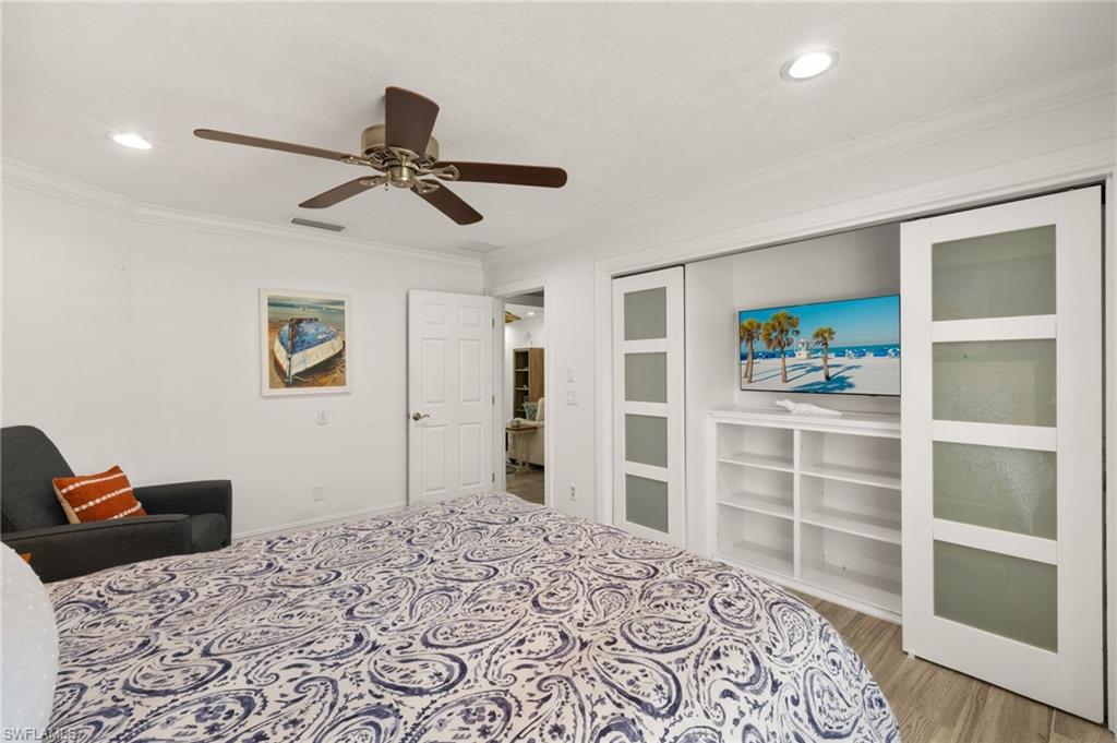 Bedroom featuring ornamental molding, ceiling fan, light wood finished floors, a closet, and recessed lighting