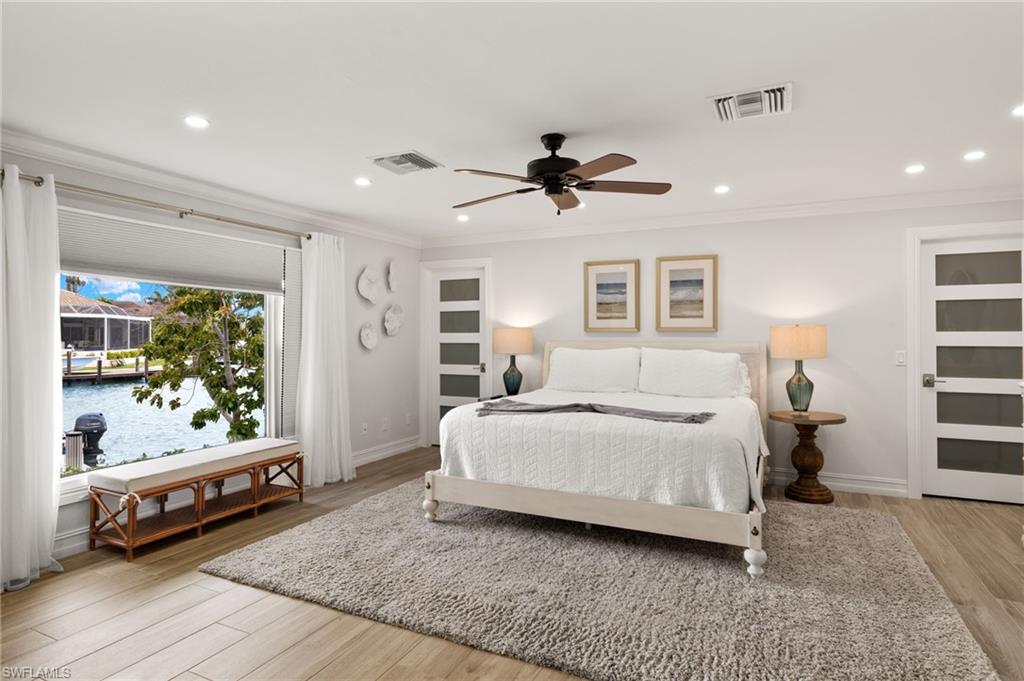 Bedroom with light wood-style flooring, recessed lighting, ornamental molding, and a ceiling fan