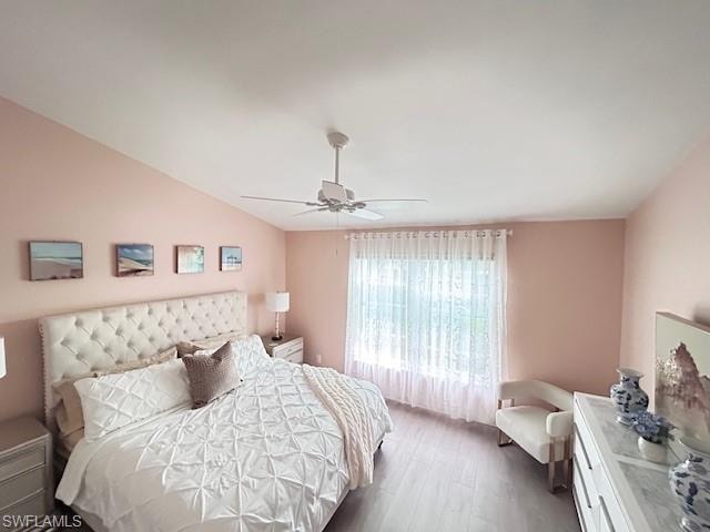 Bedroom featuring wood finished floors, ceiling fan, and lofted ceiling