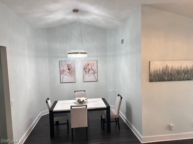 Dining room with dark wood finished floors and baseboards