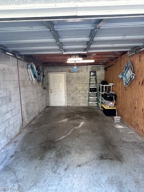Garage featuring concrete block wall
