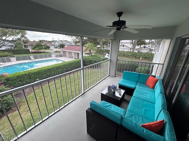 Balcony with an outdoor hangout area, view of pool area, ceiling fan, and a residential view