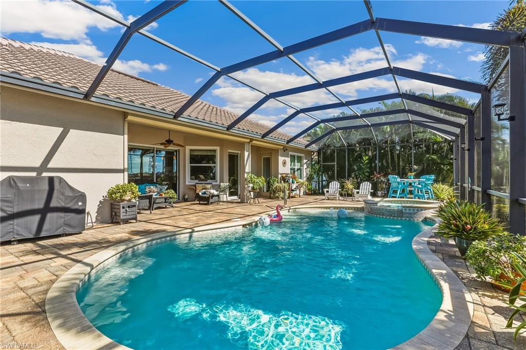 Beautiful pool area with mansard screen, brick paver decking.