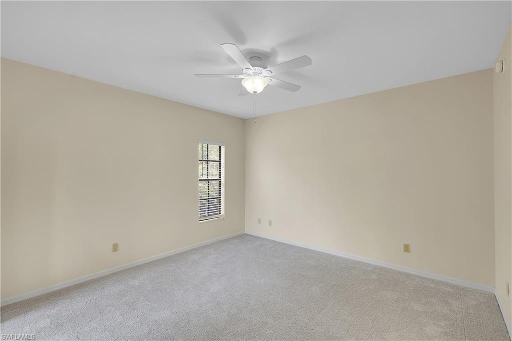 Spare room with light colored carpet and ceiling fan