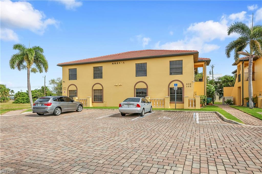 View of property with uncovered parking