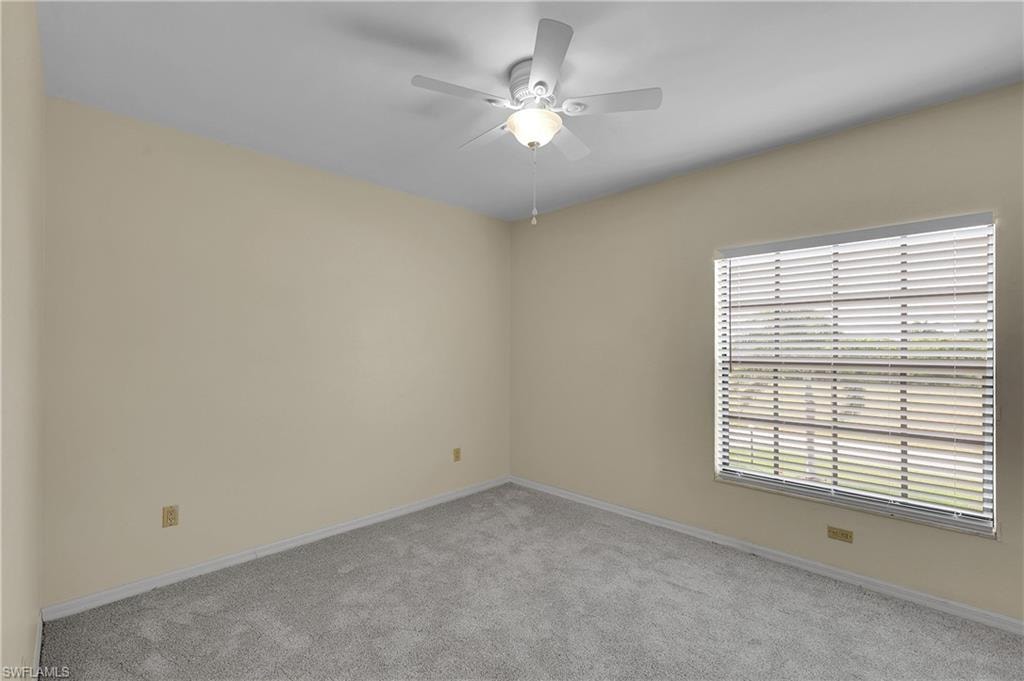 Unfurnished room with carpet floors and a ceiling fan