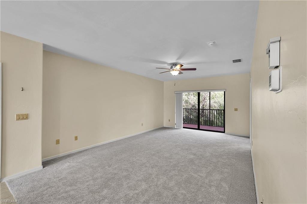 Empty room featuring light carpet and ceiling fan