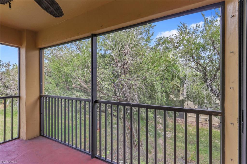 Unfurnished sunroom featuring view of wooded area