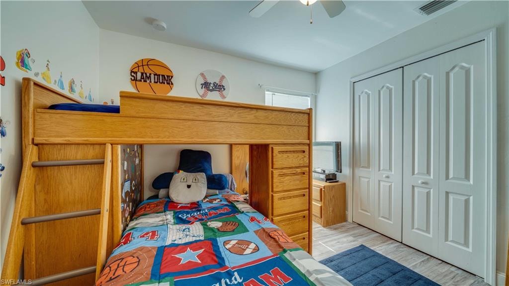 Bedroom featuring a closet, wood finished floors, and ceiling fan